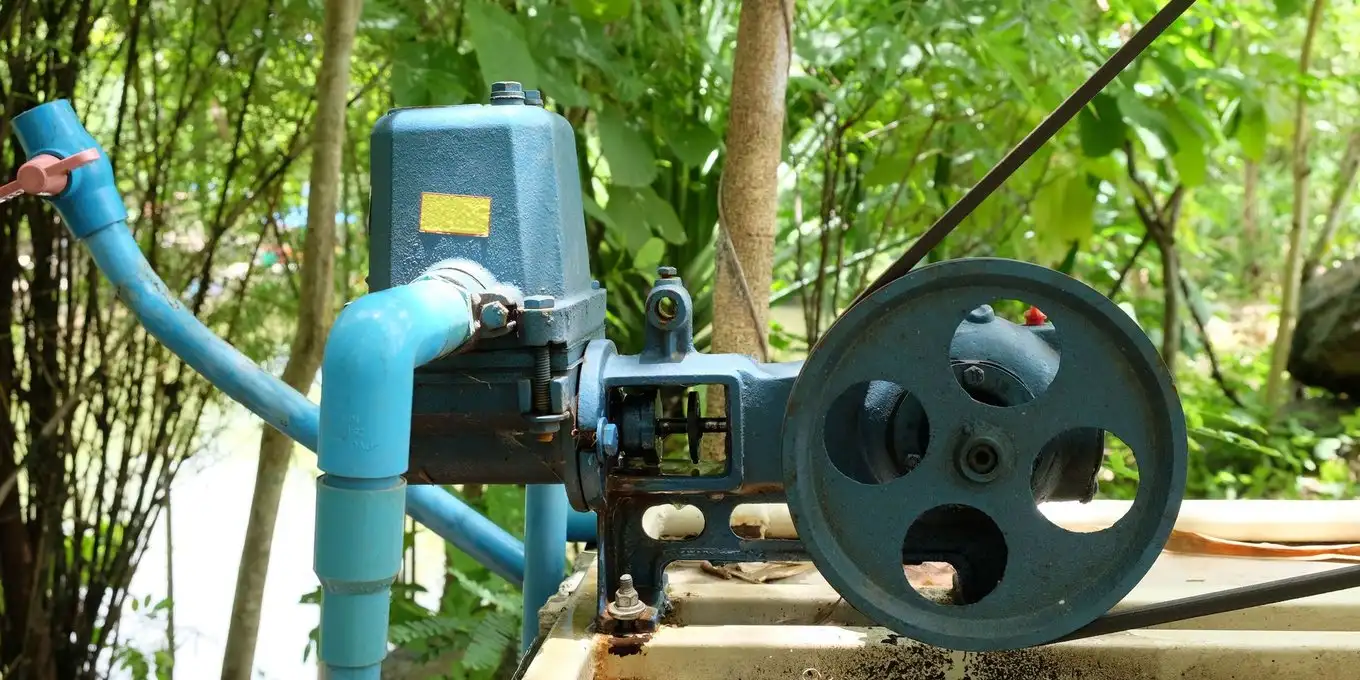 Jet pump and blue supply piping installed at a well site