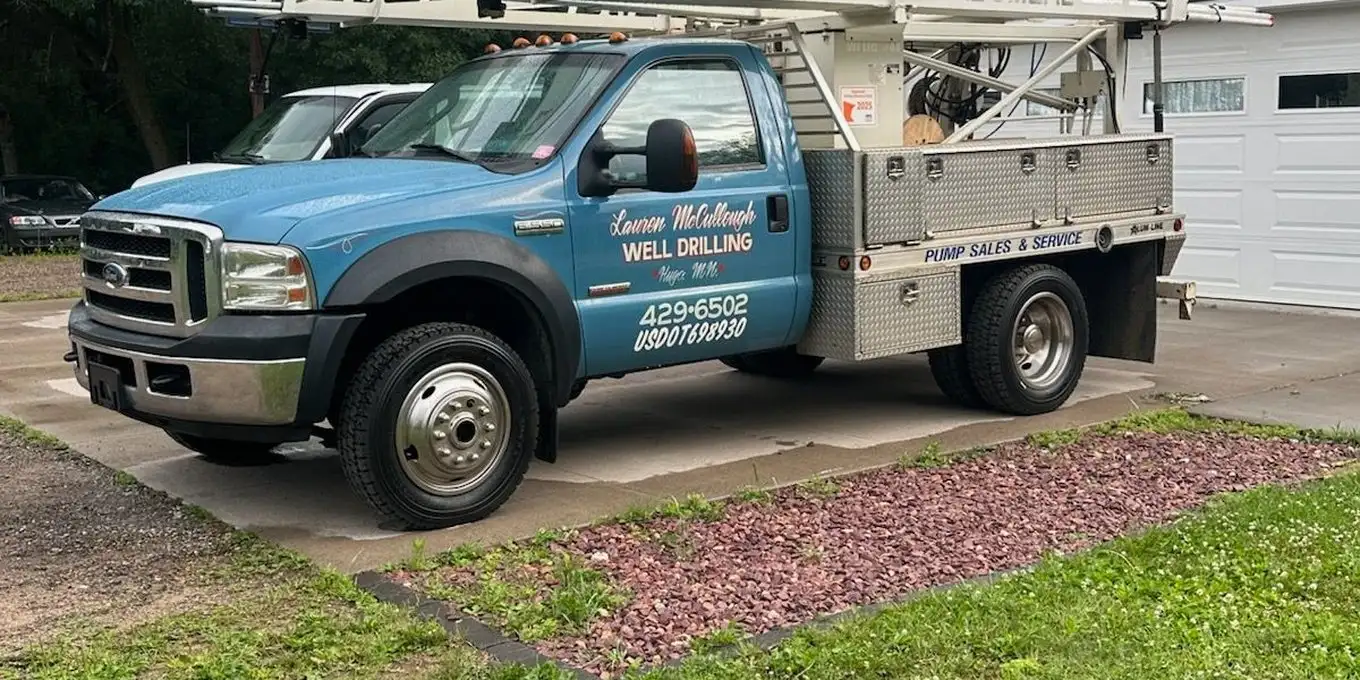 Lauren McCullough well service truck parked in a residential driveway